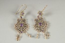 A PAIR OF 9CT GOLD DIAMOND, AMETHYST, PERIDOT AND PEARL SUFFRAGETTES COLOURED EARRINGS.