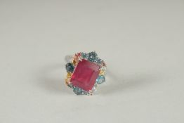 A SILVER REAL RUBY, CITRINE AND TOPAZ RING.