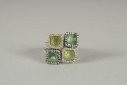 AN 18CT GOLD FOUR STONE PERIDOT AND DIAMOND RING.