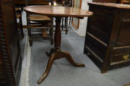 A 19th century oak circular tilt-top tripod table.