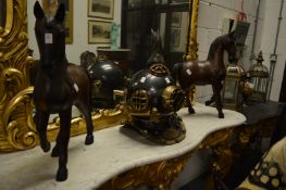 A large pair of carved wood prancing horses.