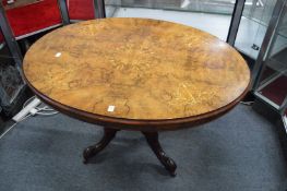 A good Victorian marquetry inlaid figured walnut oval tilt-top loo table.