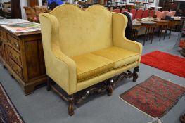A good 18th century style upholstered high back two seater dining chair on carved legs and