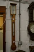 An oak cased stick barometer.
