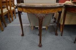 A good figured walnut shaped demi-lune fold-over card table on carved cabriole legs claw feet.