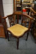 An Edwardian inlaid mahogany corner armchair.