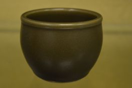 A Chinese dark green celadon glazed small brush pot.