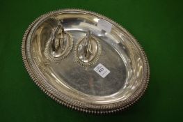 Two entree dishes and covers with handles.