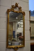 A decorative gilt framed mirror.