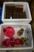 Cranberry glassware, pair of brass candlesticks, blue and white plate and group of books.