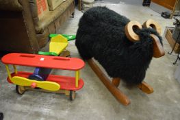 A childs painted wood model biplane and a rocking ram.