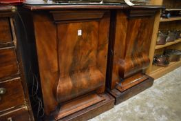 A pair of mahogany pedestal cupboards.