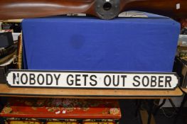 A novelty painted wood sign.