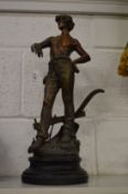 A spelter figure of a young farmer.