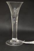 A Georgian glass with tapering bowl and tear drop in the stem.