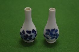 A pair of miniature Chinese blue and white bottle vases.