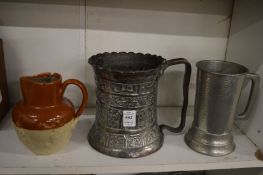 An Islamic embossed metal tankard and two other items.