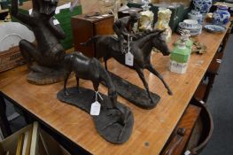 A bronze resin model of a horse and jockey together with a similar one of a horse and fowl.