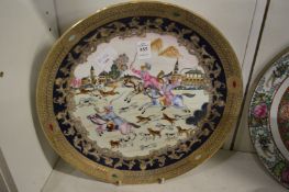 A Chinese export style circular dish decorated with a hunting scene.