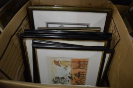 A box of assorted paintings and prints.