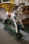 A good early small rocking horse, restored.