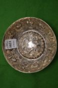 An Eastern white metal circular bowl with embossed decoration.