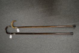 Two silver mounted walking sticks.