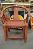 A Chinese red stained elm armchair.