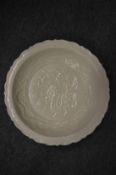 A Chinese blanc de chine circular dish with incised decoration.