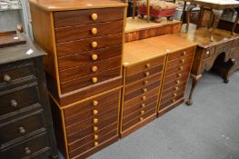 Two pairs of John Austin teak and rosewood storage chests.