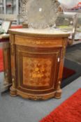 A French marble topped inlaid and ormolu mounted corner cupboard.