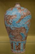A large Chinese meiping vase with incised decoration depicting dragons.