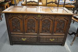 An 18th century oak marriage chest with carved decoration.
