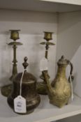 Islamic brass pot, similar ewer and a pair of candlesticks.