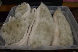 A large fluffy throw and pair of fluffy cushions.