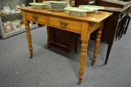 A Victorian ash two drawer side table.