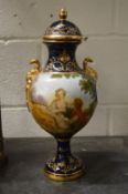 A Continental porcelain pedestal vase and cover decorated with figures in a landscape.