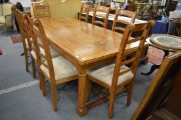 A good modern rectangular extending dining table with one leaf together with a set of eight matching