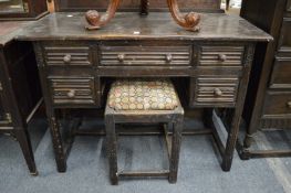 An oak dressing table with matching stool.
