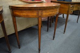 A good George III satinwood and rosewood banded demi-lune fold-over card table.