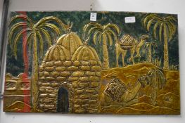 An Eastern embossed metal picture.