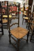 A set of six ladder back and rush seated dining chairs (faults).