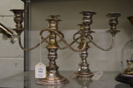 A pair of plated three light twin branch candelabra.