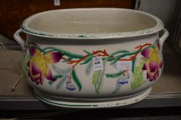 A large floral decorated pottery foot bath.