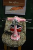 A novelty table lamp modelled as a pink Vespa scooter.