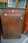 A 19th century oak hanging corner cupboard.