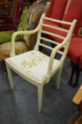 A painted dining chair with arms.