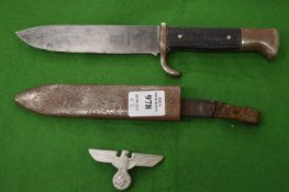 A German dagger together with a German military badge.