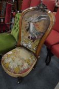 A Victorian walnut framed salon chair with bead work and embroidered upholstery.