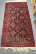 A Persian rug, deep blue ground with stylised decoration 180cm x 92cm.